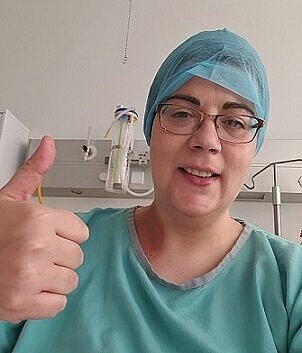 Breast cancer fighter Anita gives a thumbs up from one of her treatment appointments.